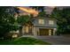 Beautiful home with a two-car garage, stone accents, and professional landscaping at sunset at 2116 Strasburg Ct, Atlanta, GA 30338