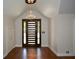 Grand foyer featuring a modern front door, hardwood floors, and a stylish chandelier at 2116 Strasburg Ct, Atlanta, GA 30338