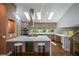 Bright kitchen featuring stone countertops, stainless steel appliances, wine cooler, bar seating and skylights at 2116 Strasburg Ct, Atlanta, GA 30338