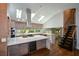 Open concept kitchen with large island, stainless steel appliances, skylights and adjacent staircase at 2116 Strasburg Ct, Atlanta, GA 30338
