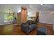 Inviting living room with hardwood floors, skylights, stylish chandelier, and open layout to the kitchen and stairs at 2116 Strasburg Ct, Atlanta, GA 30338