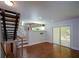 Open-concept living space with hardwood floors, modern staircase, and sliding glass doors at 2116 Strasburg Ct, Atlanta, GA 30338