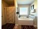 Bright bathroom featuring a tub, shower with curtain, and natural light at 3227 Puritan Way, Mcdonough, GA 30252
