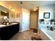Bathroom featuring double sinks, framed mirrors, and a separate tub at 3227 Puritan Way, Mcdonough, GA 30252