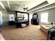 Spacious bedroom boasts a tray ceiling, ceiling fan, and elegant four-poster bed at 3227 Puritan Way, Mcdonough, GA 30252