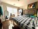 Cozy bedroom featuring a patterned comforter, natural light, and a mirror, creating a relaxing atmosphere at 3227 Puritan Way, Mcdonough, GA 30252