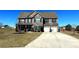 Beautiful two-story home with stone accents, a basketball hoop, a well-manicured lawn, and a long driveway at 3227 Puritan Way, Mcdonough, GA 30252
