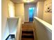 Upstairs hallway with neutral walls, a staircase leading down, and a bathroom at the end of the hall at 3227 Puritan Way, Mcdonough, GA 30252