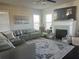 Spacious living room boasts a plush sectional sofa, a fireplace with a mantel, and large windows for ample light at 3227 Puritan Way, Mcdonough, GA 30252