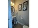 Cozy powder room features a pedestal sink, decorative mirror, and elegant wall art at 3227 Puritan Way, Mcdonough, GA 30252