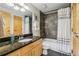 Modern bathroom with a granite countertop vanity, tiled shower, and modern fixtures at 5200 Peachtree Rd # 3420, Atlanta, GA 30341