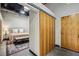 Modern bedroom with a sliding wooden door, industrial ceiling, and a comfortable bed with plush pillows at 5200 Peachtree Rd # 3420, Atlanta, GA 30341