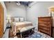 Cozy bedroom with a bed, wooden dresser, accent rug, and ample natural light at 5200 Peachtree Rd # 3420, Atlanta, GA 30341