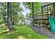 Custom-built treehouse with a slide, ladder and hammocks overlooking the backyard at 5285 Bannergate Dr, Johns Creek, GA 30022