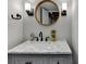 Beautifully updated bathroom with marble countertops, modern fixtures, and a decorative mirror at 5285 Bannergate Dr, Johns Creek, GA 30022