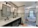 Elegant bathroom featuring dual sinks, modern fixtures, and a luxurious soaking tub at 5285 Bannergate Dr, Johns Creek, GA 30022