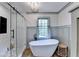 Bright bathroom featuring a modern soaking tub, glass-enclosed shower, and natural light at 5285 Bannergate Dr, Johns Creek, GA 30022
