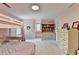Pink bedroom featuring a bunk bed with desk and built-in shelving near window seat at 5285 Bannergate Dr, Johns Creek, GA 30022