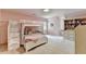 Pink bedroom featuring a bunk bed, a small desk and a window seat with built-in shelving at 5285 Bannergate Dr, Johns Creek, GA 30022