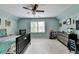 Spacious bedroom featuring light blue walls, ceiling fan, and large window letting in natural light at 5285 Bannergate Dr, Johns Creek, GA 30022