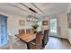 Elegant dining room with wood table, woven chairs, modern light fixture, and hardwood floors at 5285 Bannergate Dr, Johns Creek, GA 30022