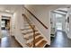 Bright entryway with hardwood floors and a staircase with wooden handrail and white spindles at 5285 Bannergate Dr, Johns Creek, GA 30022