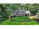 Charming single-story home with beautiful landscaping, featuring a classic brick facade and mature trees at 5285 Bannergate Dr, Johns Creek, GA 30022