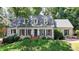 Charming brick home with dormer windows, a landscaped front yard and a welcoming entrance at 5285 Bannergate Dr, Johns Creek, GA 30022