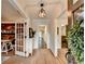 Inviting foyer with beautiful hardwood floors, complemented by views of a stylish office and kitchen at 5285 Bannergate Dr, Johns Creek, GA 30022