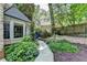 Stone walkway with professionally landscaped flower beds, lush plants, and manicured bushes at 5285 Bannergate Dr, Johns Creek, GA 30022