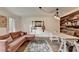 Comfortable living room boasts a plush sectional sofa, wood accent wall, and stylish lighting at 5285 Bannergate Dr, Johns Creek, GA 30022