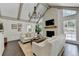 Spacious living room featuring a vaulted ceiling, large windows, and a cozy fireplace at 5285 Bannergate Dr, Johns Creek, GA 30022