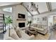 Open living room featuring a cozy fireplace and seamless connection to the dining area at 5285 Bannergate Dr, Johns Creek, GA 30022