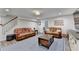 Spacious living room featuring hardwood floors, leather furniture, and plenty of natural light at 5285 Bannergate Dr, Johns Creek, GA 30022