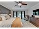 Bright main bedroom with a ceiling fan, bay window, and neutral color palette at 5285 Bannergate Dr, Johns Creek, GA 30022