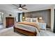 Well-lit main bedroom featuring a large bed, neutral carpet, and ample storage at 5285 Bannergate Dr, Johns Creek, GA 30022