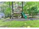 Custom-built treehouse with a ladder, slide and hammocks for backyard fun at 5285 Bannergate Dr, Johns Creek, GA 30022