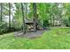 Custom-built treehouse with a slide, ladder, and hammock overlooking the lush, wooded backyard at 5285 Bannergate Dr, Johns Creek, GA 30022