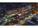 Night time view of mixed use development with shops, apartments, parking and street lighting at 1003 River Plantation Dr, Woodstock, GA 30188