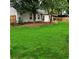 Expansive backyard with mature trees, covered patio, and privacy fence at 1003 River Plantation Dr, Woodstock, GA 30188