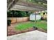 Backyard featuring a wooden shed and privacy fence, accessible from a concrete patio at 1003 River Plantation Dr, Woodstock, GA 30188