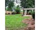 Fenced backyard featuring a pergola with concrete patio, and well-maintained lawn at 1003 River Plantation Dr, Woodstock, GA 30188