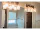 Bathroom features light fixture, window, bathtub and access to a walk-in closet at 1003 River Plantation Dr, Woodstock, GA 30188