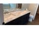 Bathroom with dual sink vanity featuring a white marble countertop and dark wood cabinets at 1003 River Plantation Dr, Woodstock, GA 30188