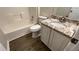 Bathroom features wood floor, vanity with granite countertop, toilet and combination tub/shower at 1003 River Plantation Dr, Woodstock, GA 30188