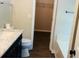 Bathroom features wood floors, toilet, vanity with marble countertop and access to walk-in closet and bathtub at 1003 River Plantation Dr, Woodstock, GA 30188