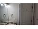 Bathroom with a framed mirror, brushed bronze fixtures, and a door with a hook at 1003 River Plantation Dr, Woodstock, GA 30188