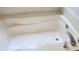 Close-up of a clean white bathtub with chrome faucet and fixtures, showcasing its modern design at 1003 River Plantation Dr, Woodstock, GA 30188