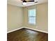 Comfortable bedroom featuring a ceiling fan, natural light from the window, and hardwood floors at 1003 River Plantation Dr, Woodstock, GA 30188