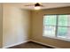 Bedroom with a ceiling fan, wood-look flooring and a window overlooking backyard at 1003 River Plantation Dr, Woodstock, GA 30188